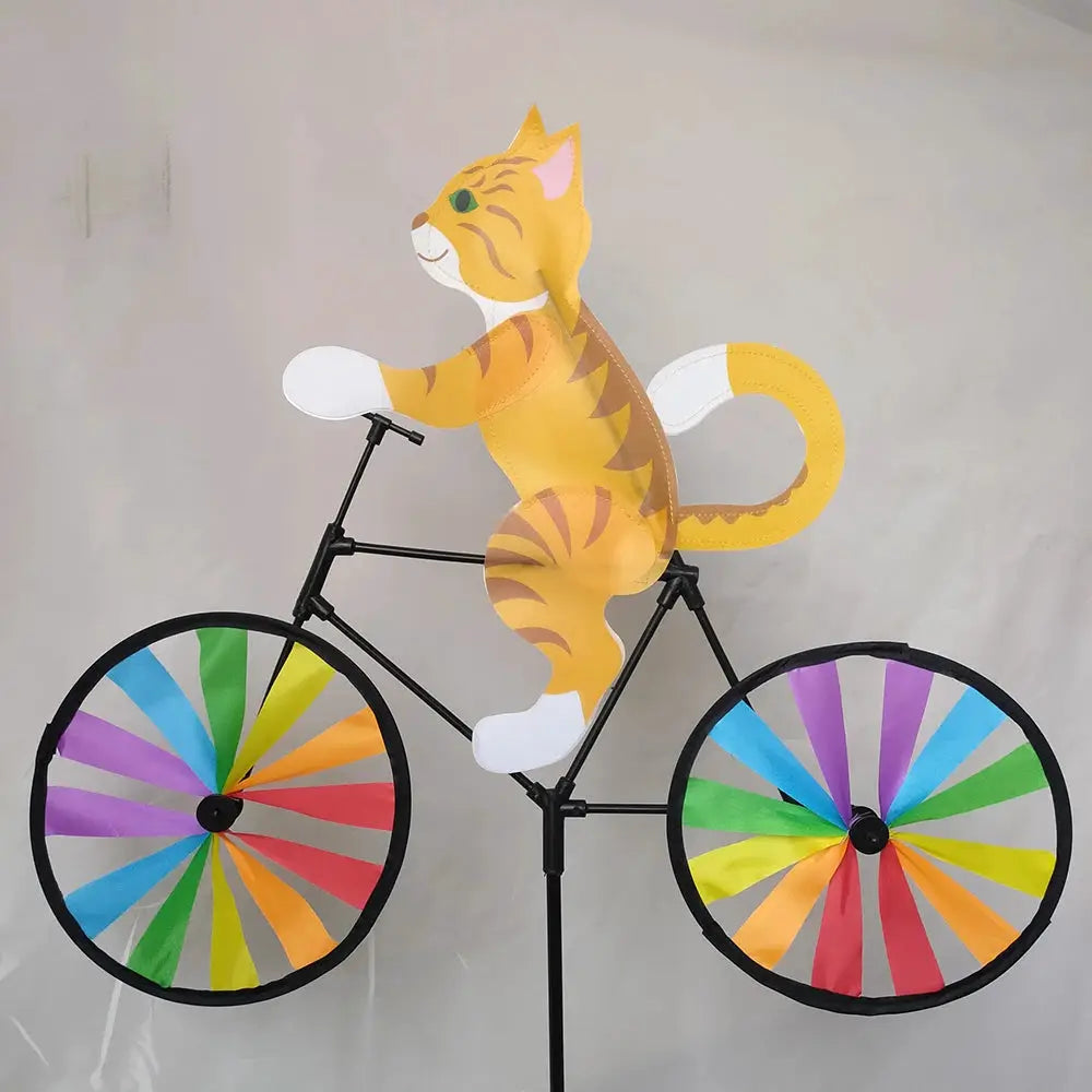 Animal riding wind spinner on a standing bicycle pole; yellow tiger figure with rainbow-spoked wheels for garden decor