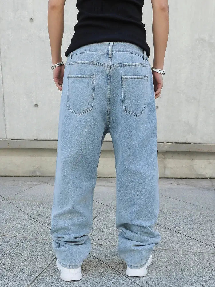 Baggy light-blue denim jeans, oversized straight fit with back pockets, casual streetwear wide-leg style.