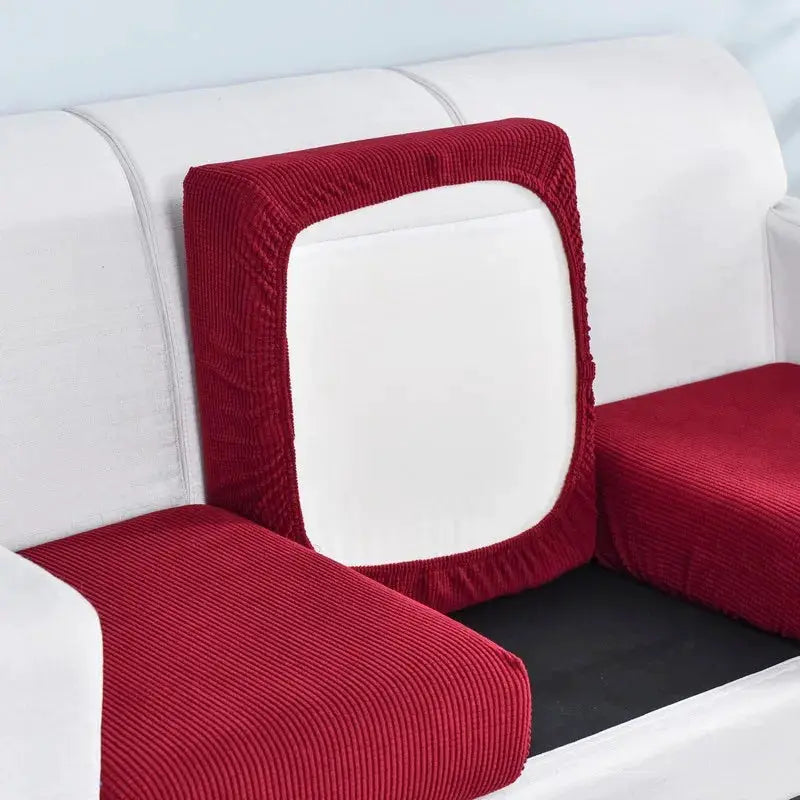 Three red polar fleece sofa cushion covers with elastic edges on a white sofa