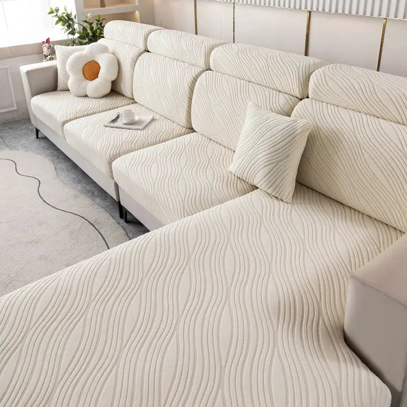 Beige plush elastic sofa cover with a wavy pattern for a sectional sofa