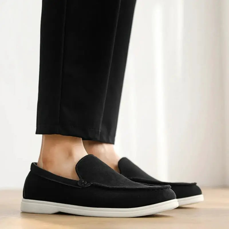 Men's black suede loafers with white sole; slip-on driving flats.