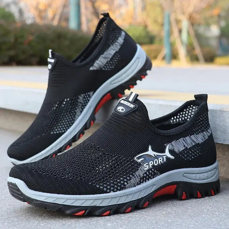 Two black mesh sport sneakers for men; breathable with gray midsoles and red-outsole accents