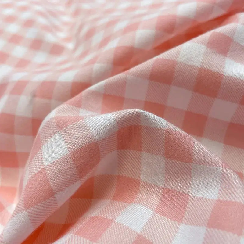 Nordic plaid cotton bedding set by Simples Market in pink and white gingham.