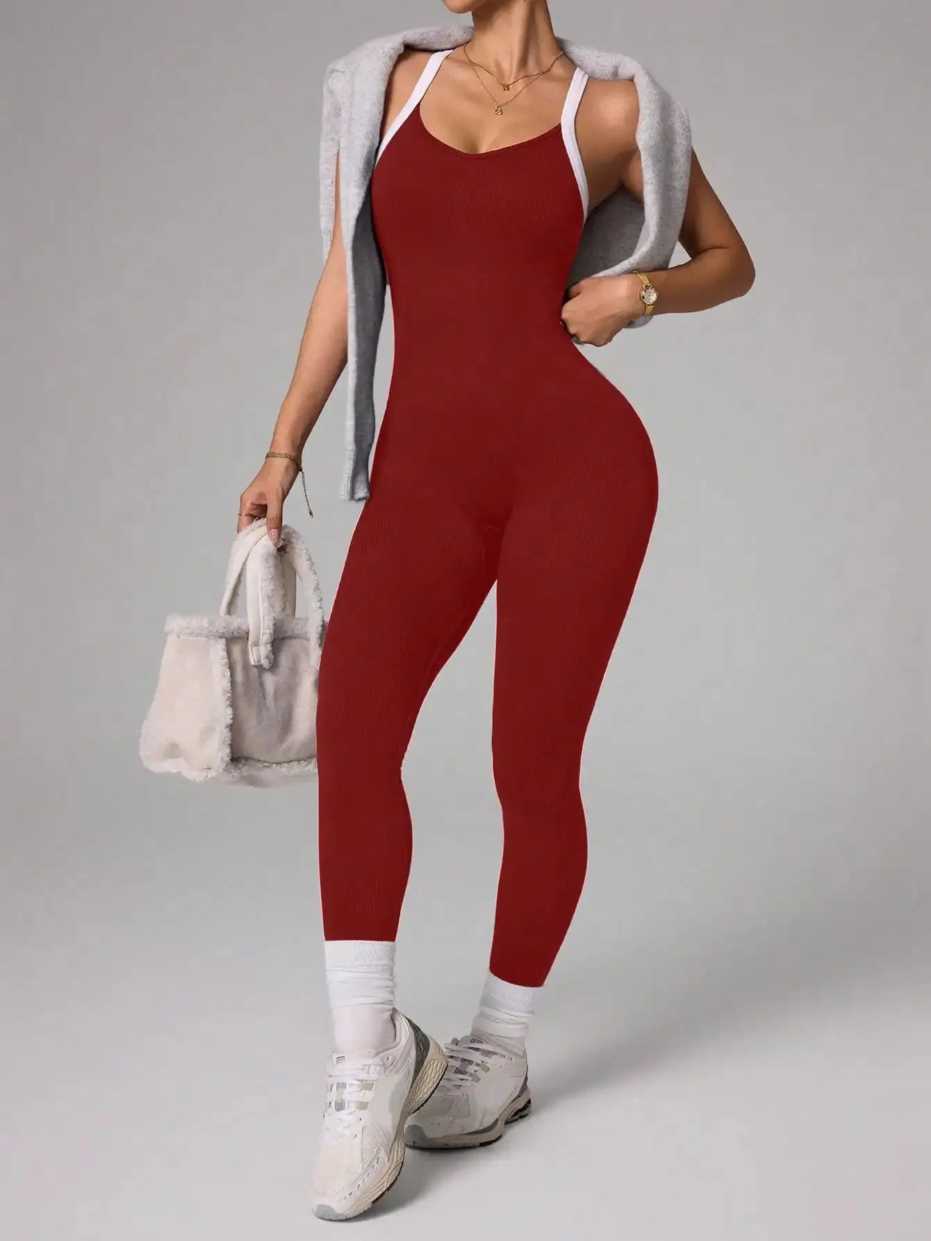 Red cross-shoulder strap yoga jumpsuit with seamless quick-dry fabric for fitness.