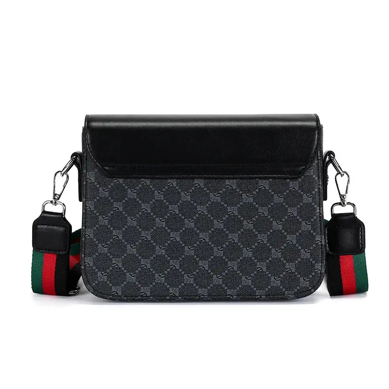 Men's crossbody bag with jacquard pattern, black leather flap, grey body, and green-red-green striped strap