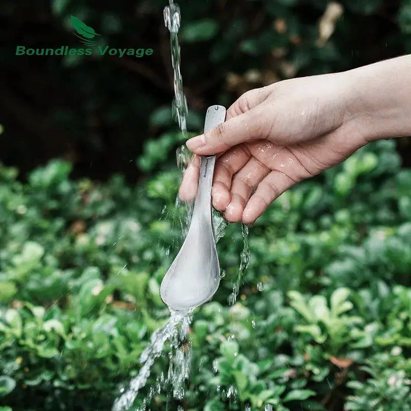 Boundless Voyage titanium spoon, outdoor camping flatware, being rinsed under running water.