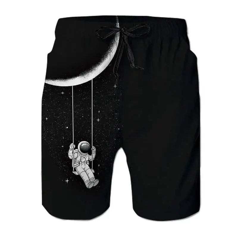 Men's black board shorts with space-themed print of an astronaut swinging from a crescent moon