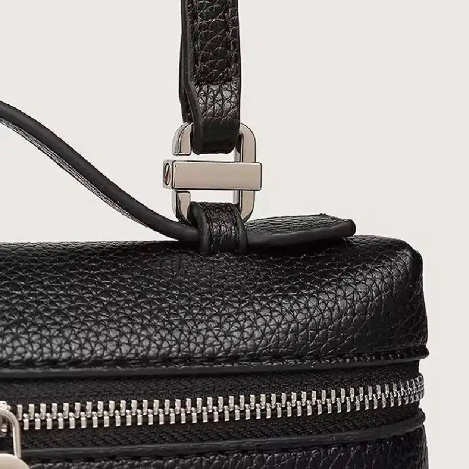 Mini black lychee-grain leather crossbody bag with silver hardware and zipper