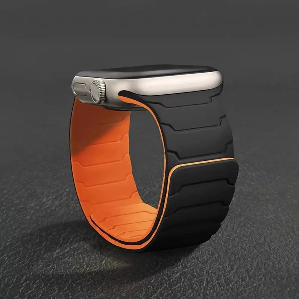 Silicone magnetic Apple Watch strap, black exterior with orange interior, for 40–49mm bands.
