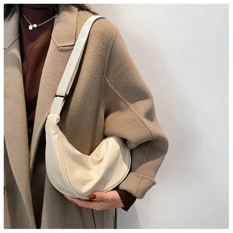 Nylon dumpling bag, lightweight cream crossbody bag with a wide shoulder strap