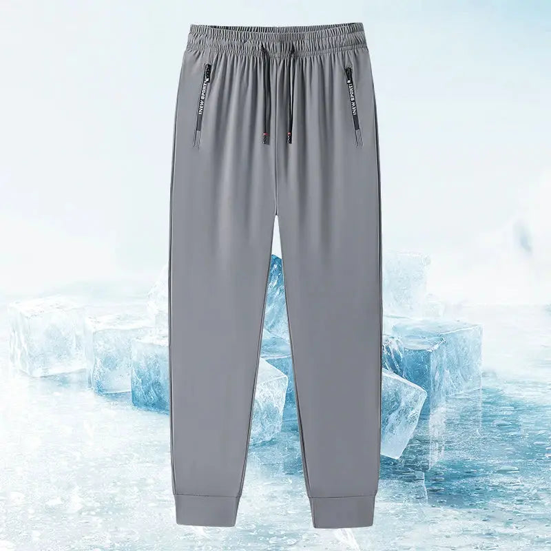 Men's grey fitness jogger pants by Simples Market with zippered pockets and stretch fabric for running and casual wear