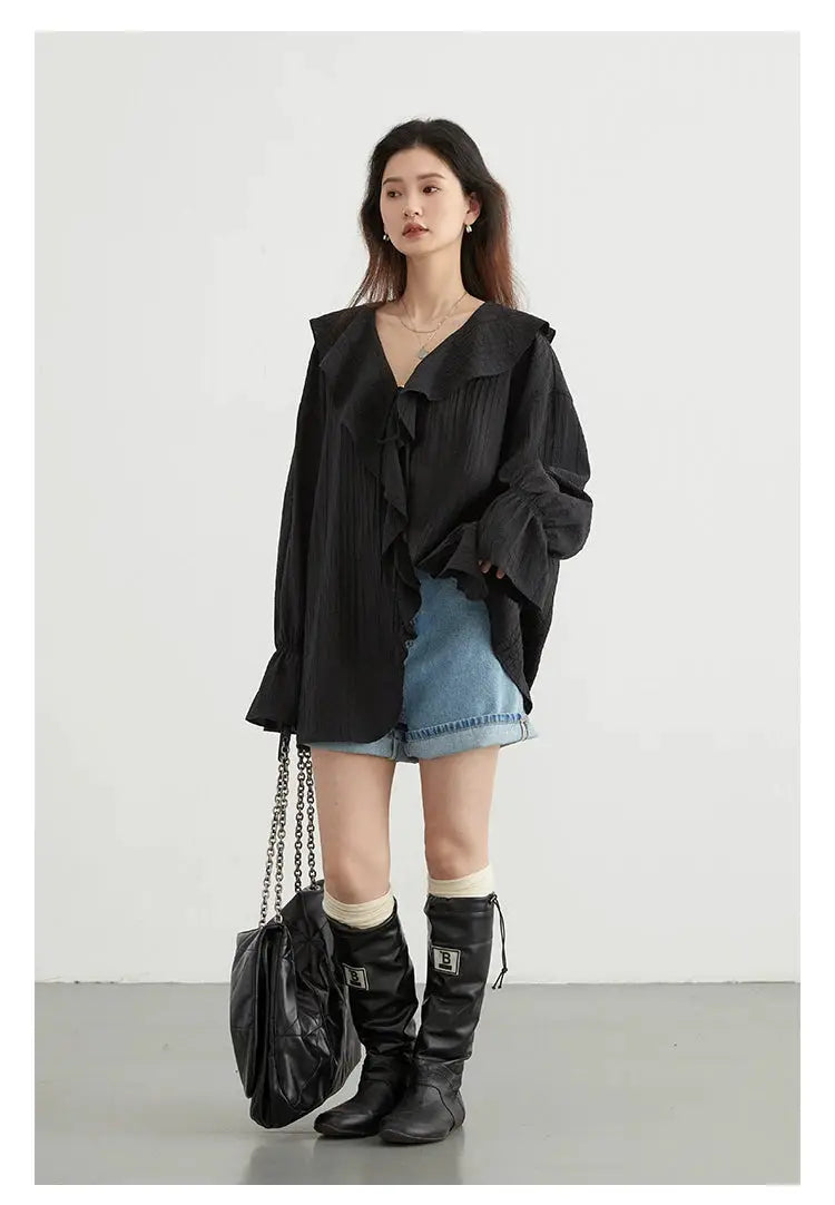 CHIC VEN women's black loose blouse with ruffle trim and V-neck, shown with denim shorts and knee-high boots