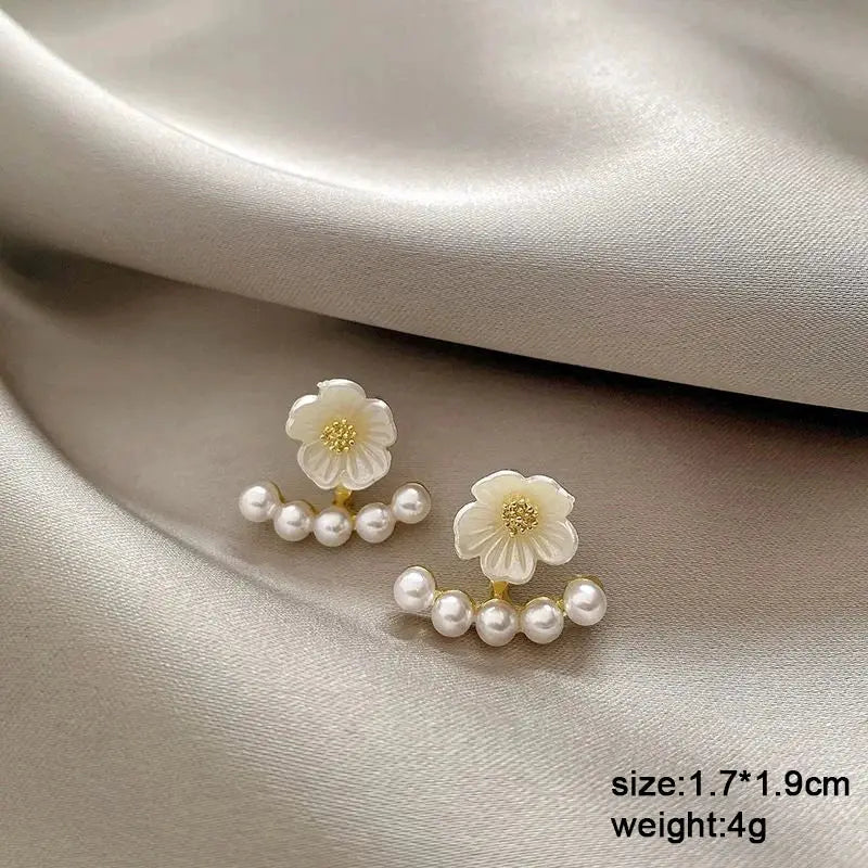 White flower dangle earrings with gold center and pearl fringe, pair
