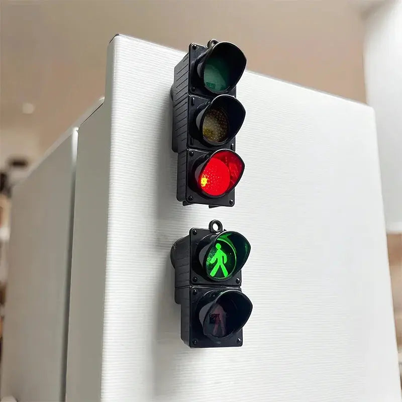 Traffic light magnetic refrigerator magnets; two black signal units with red, yellow and green lights and a green pedestrian signal