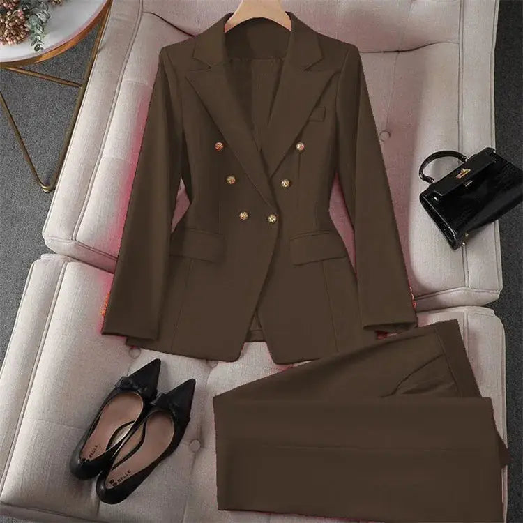 Brown two-piece blazer and pants suit for women, double-breasted with gold buttons, displayed with black flats.