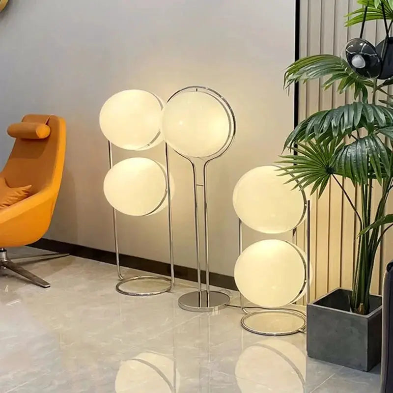 White acrylic globe LED floor lamps on chrome stands; set of five for modern living room decor