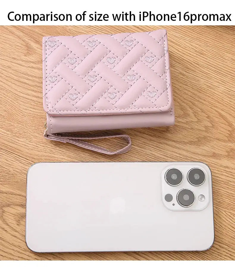 Women's pink quilted wallet with wrist strap, zip closure, and large-capacity card holder