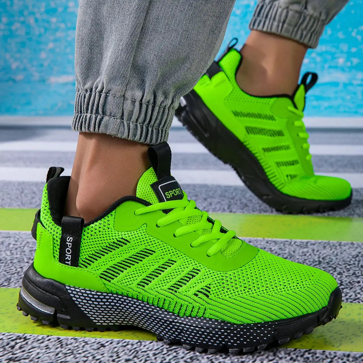 Pair of men's neon green running shoes, lightweight breathable mesh sneakers with lace-up and SPORT label