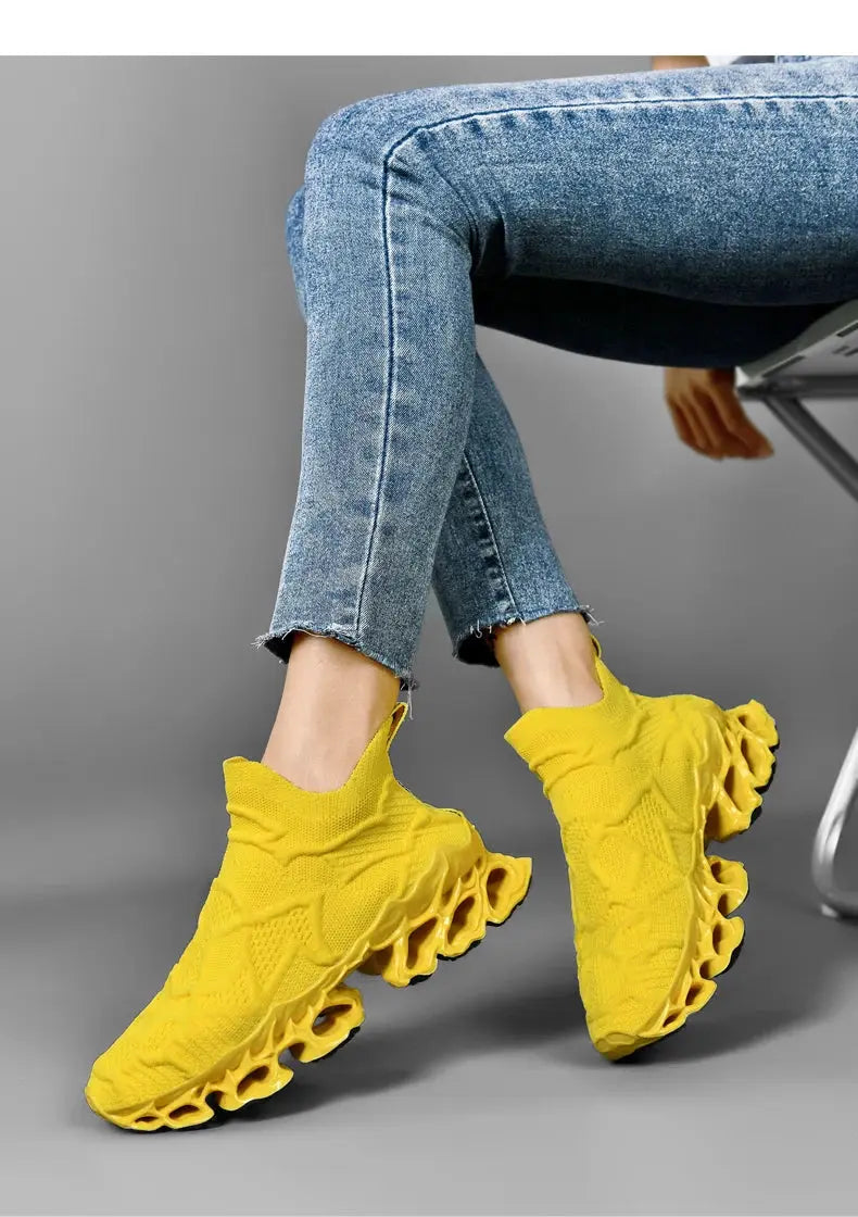Yellow knit sock-style sneakers with a sculpted hollow outsole.