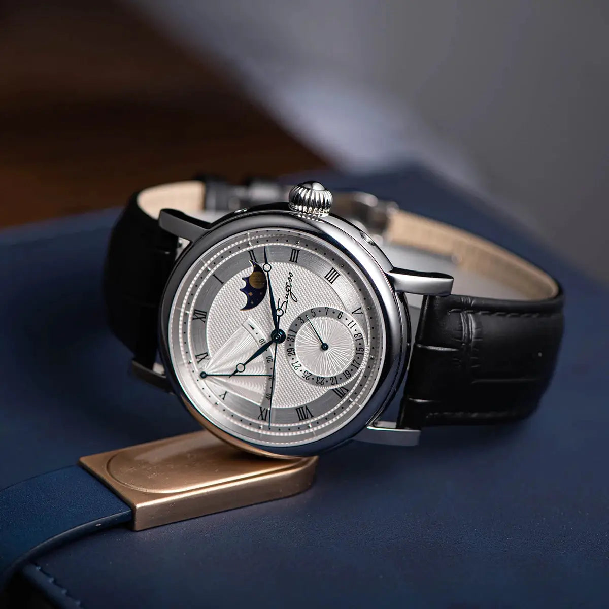 Sugess Moonphase men's automatic watch with silver case, sapphire glass, and black leather strap.