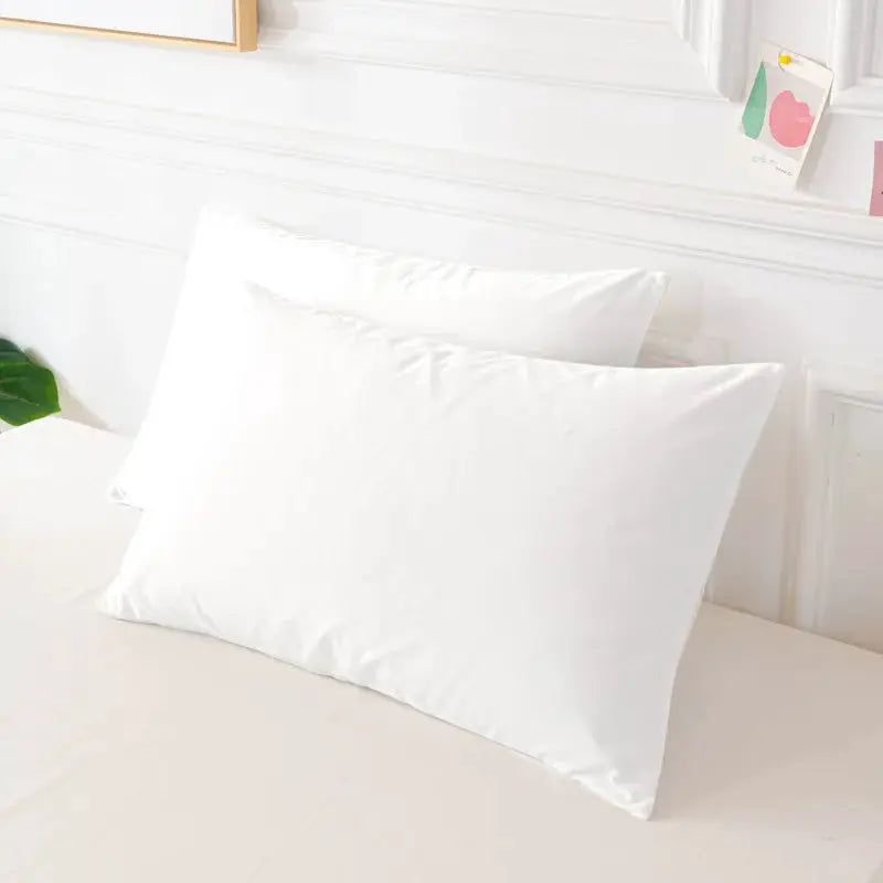 Pillow covers, white rectangular, 2 pieces on a neatly made bed
