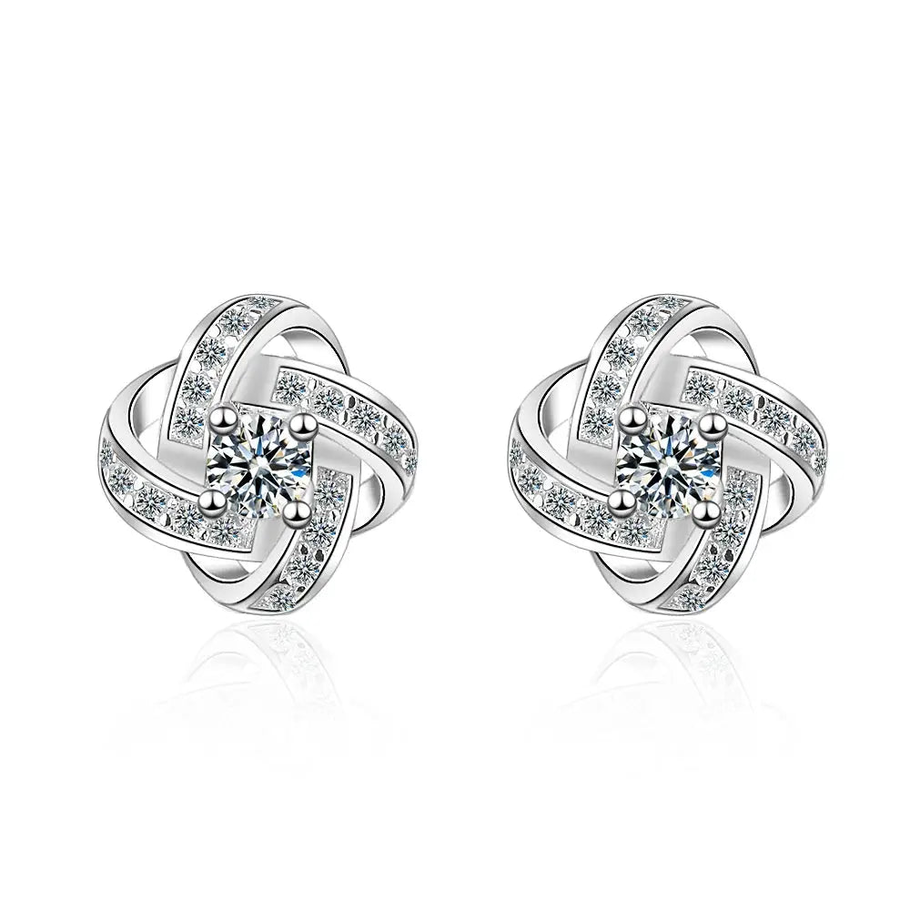 Sterling silver earrings pair with cubic zirconia in a twisted heart knot design