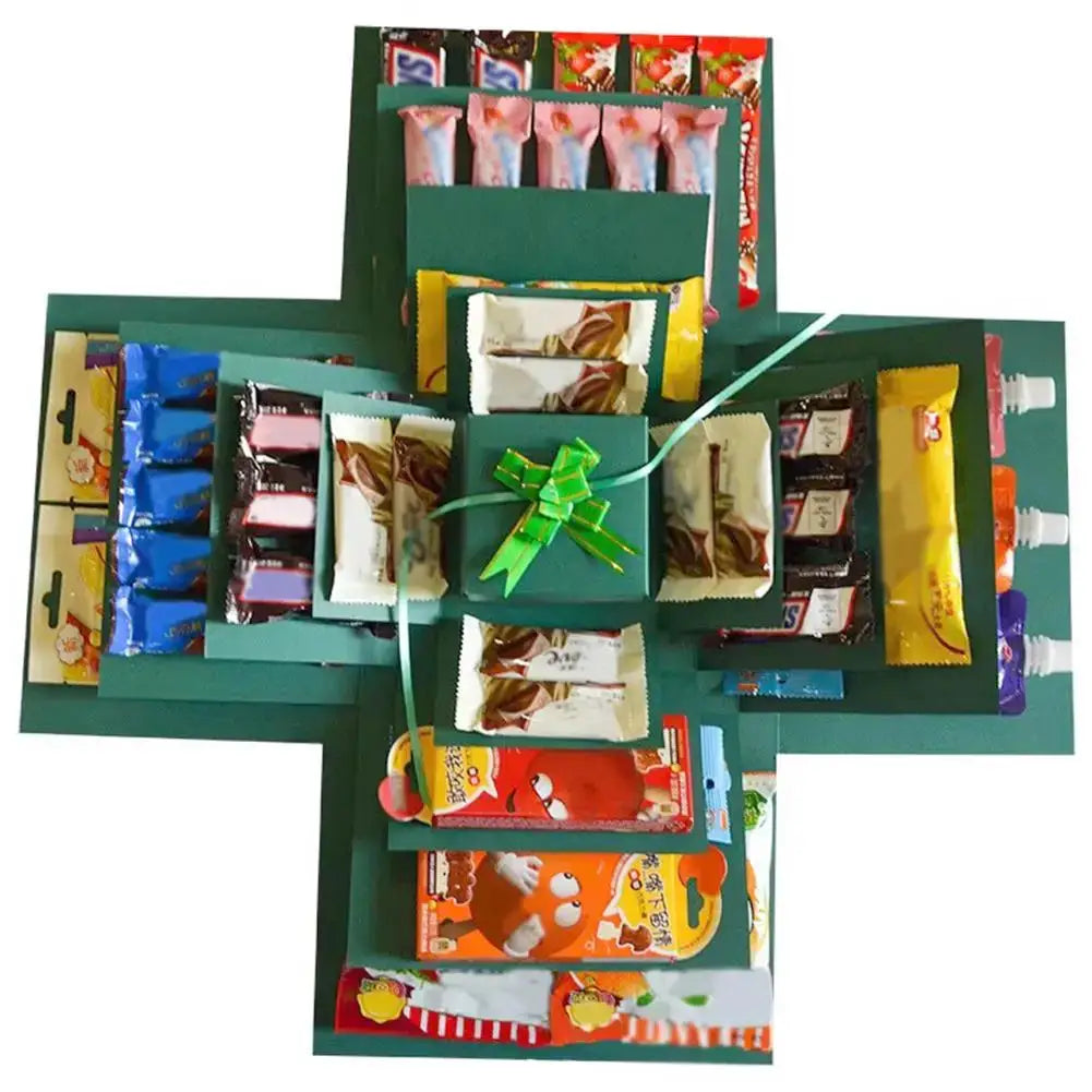 DIY Explosion Photo Album Gift Box by Simples Market in green with assorted snack packets on a fold-out scrapbook layout