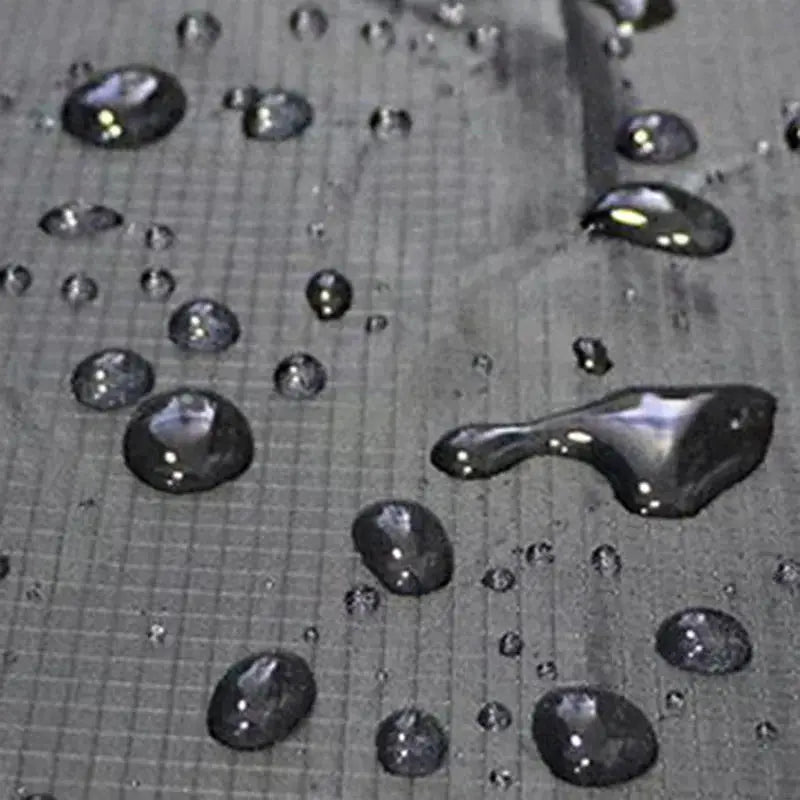 Universal car seat protector in dark grey Oxford fabric with water beads on surface