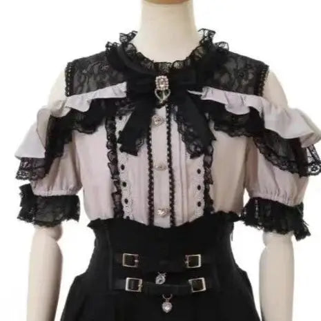 Girls' Lolita lace blouse in pink with black lace trim, ruffles, and bow accents.