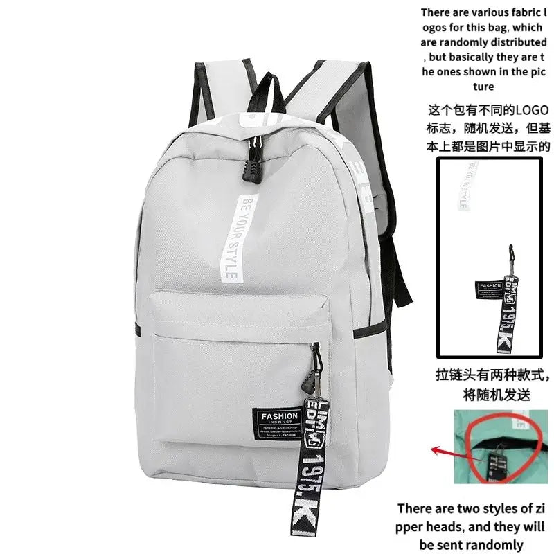 Backpack by Simples Market, gray large-capacity unisex bag with front zip pocket and branded strap
