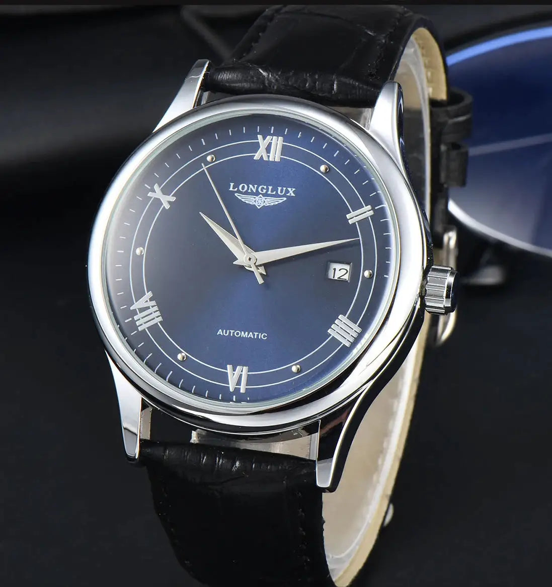 LONGLUX automatic men's watch with blue dial, silver case, Roman numerals, date window and black leather strap.
