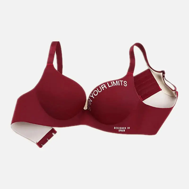 Red wireless bra with white printed letters on cups; seamless bralette style