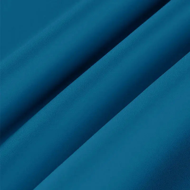 Men's short-sleeve shirt fabric close-up in blue, showing solid textile texture