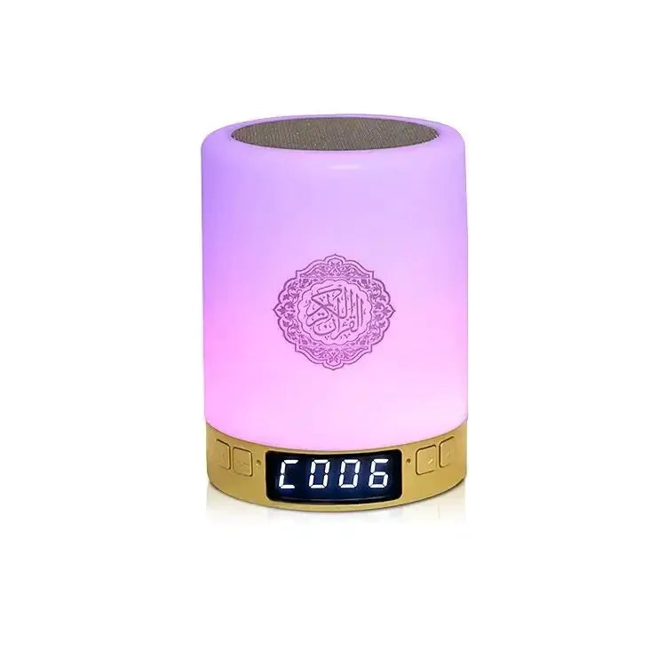Portable sound machine with LED night light and Bluetooth speaker, purple glow and digital display on gold base