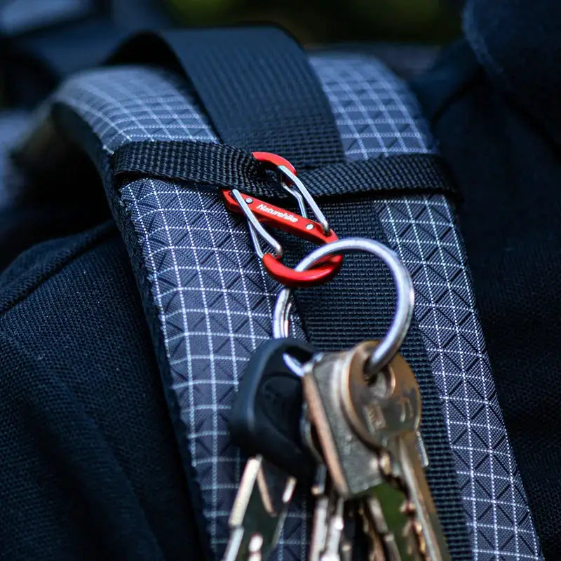Naturehike S-shaped mountaineering buckle keychain with red aluminum carabiner on a backpack strap