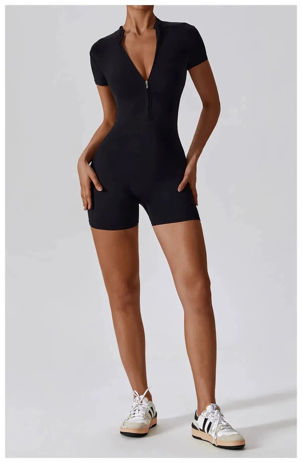Women's black zip-front short-sleeve yoga jumpsuit, quick-dry breathable, tight-fit.