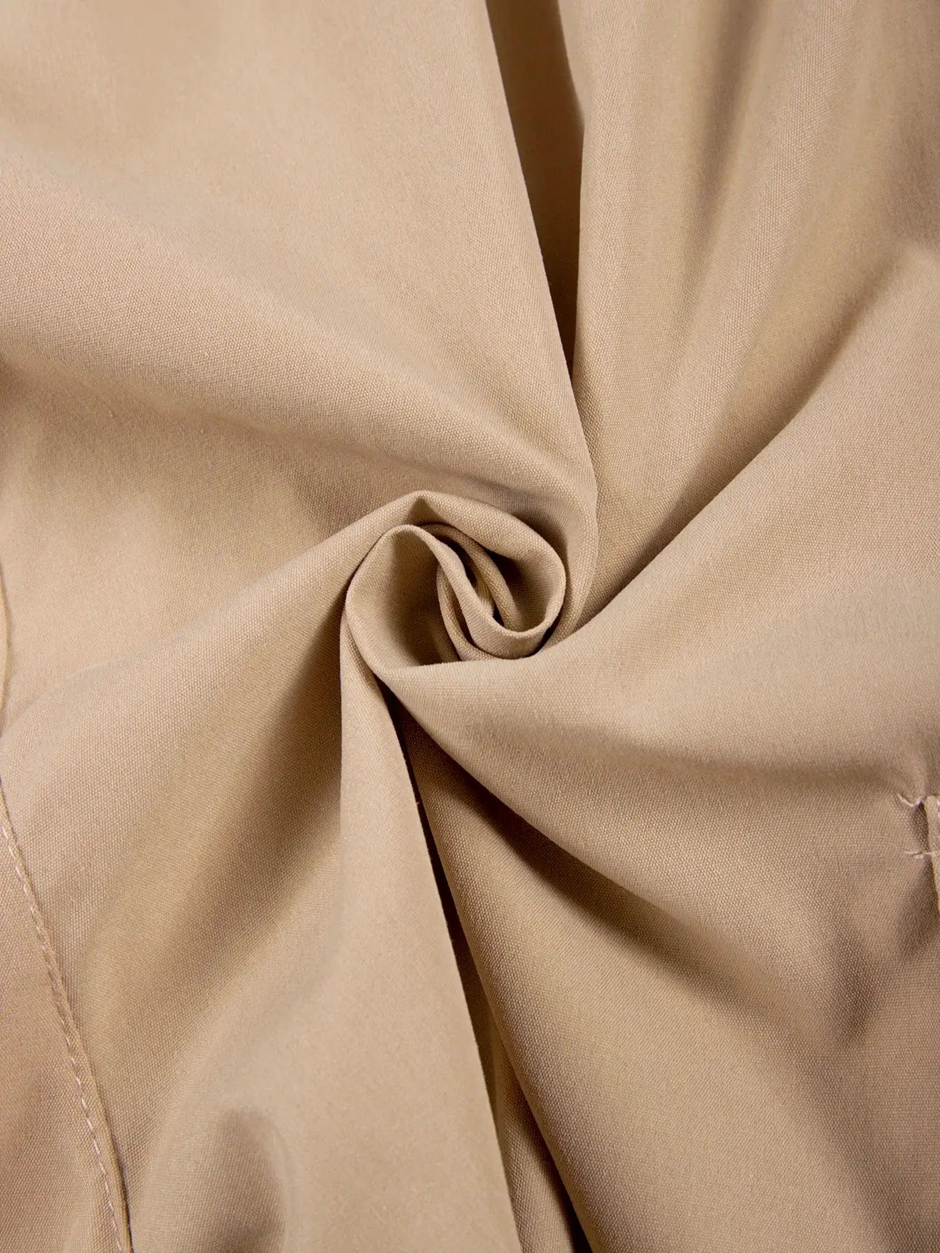 Summer men's cargo shorts beige fabric close-up with soft fold texture