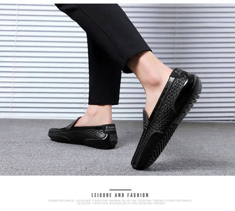 Pair of men's black genuine leather loafers, slip-on driving shoes with textured upper