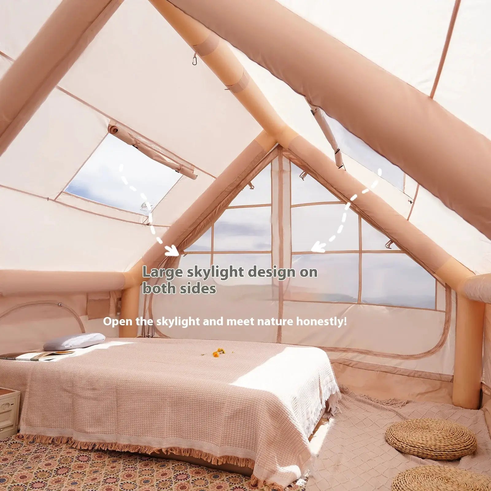 Inflatable camping tent interior in beige with large skylight and cozy bedroom setup.