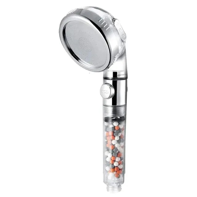 Handheld chrome spa shower head with 3 functions and clear ion-filter cartridge beads.