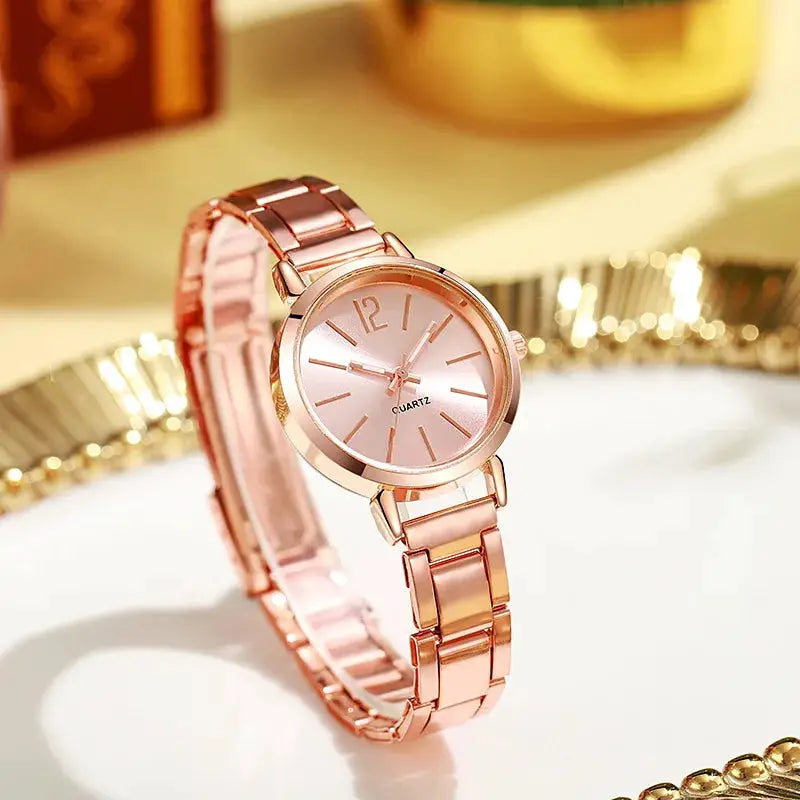 Rose gold women's wristwatch with bracelet strap and minimalist dial, quartz movement