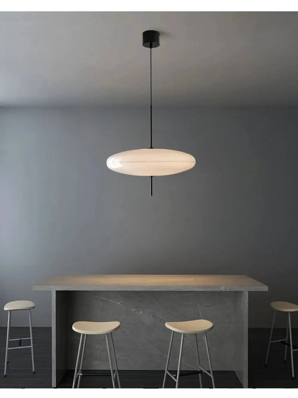 Nordic LED pendant light with flying saucer shade, white fixture over grey marble kitchen island with four stools