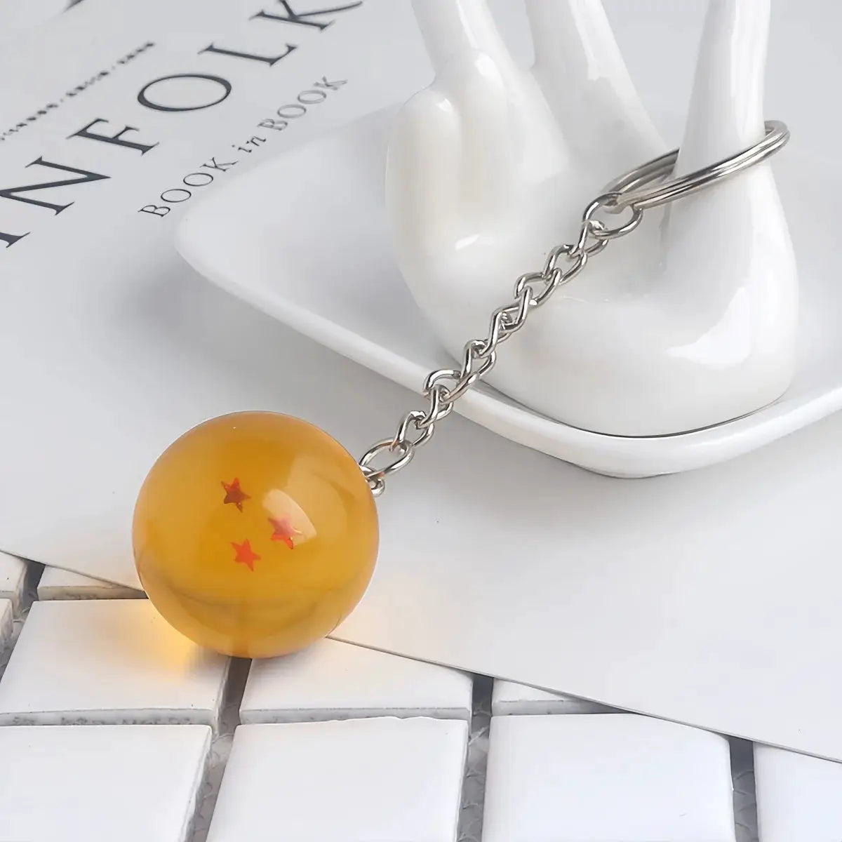 Dragon Ball keychain with orange bead featuring red stars on metal chain and ring