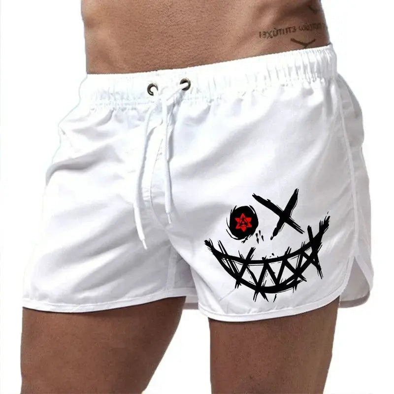 Men's white board shorts with drawstring and a large black stitched-face graphic with a red eye.