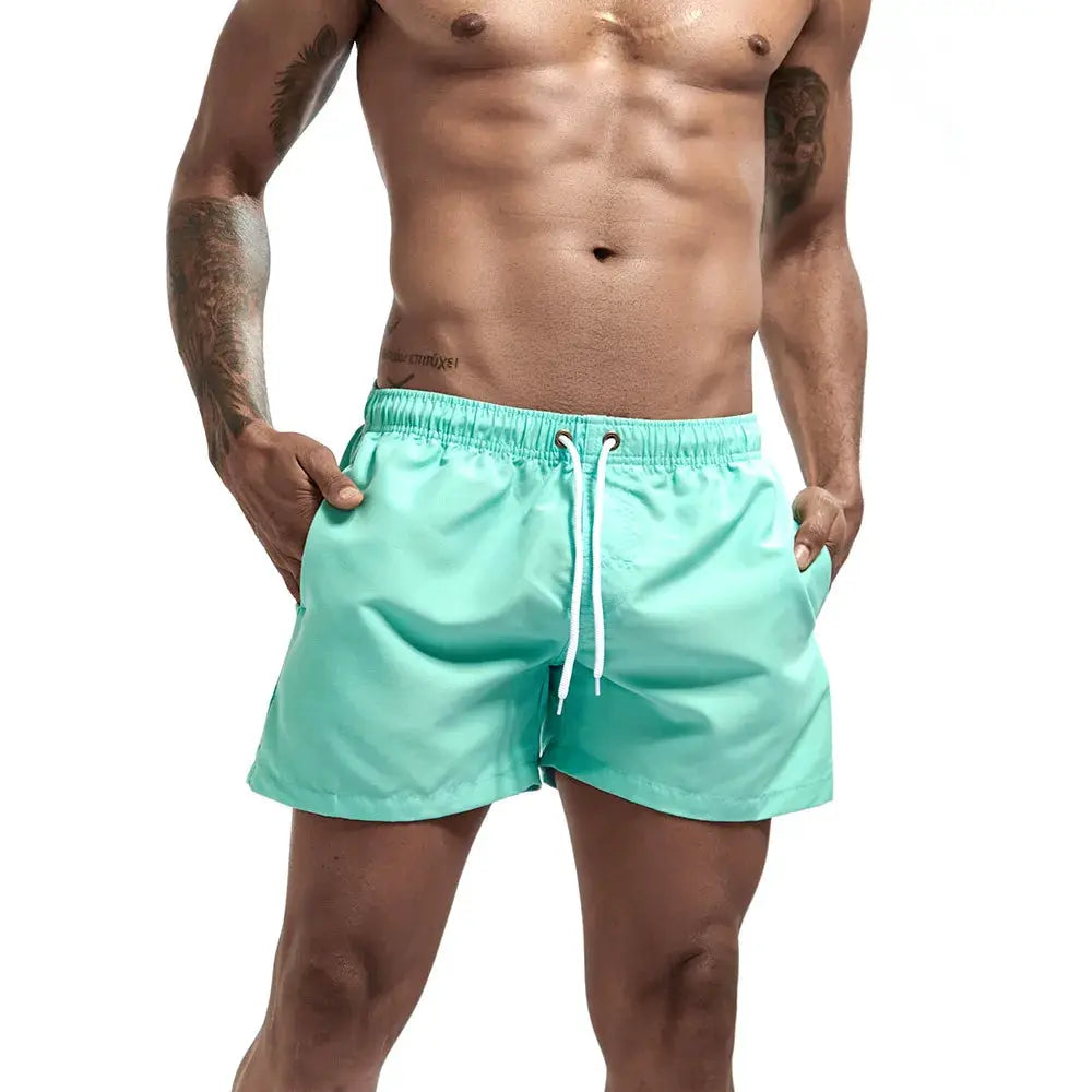 Simples Market men's swim trunks in mint green with white drawstring and side pockets