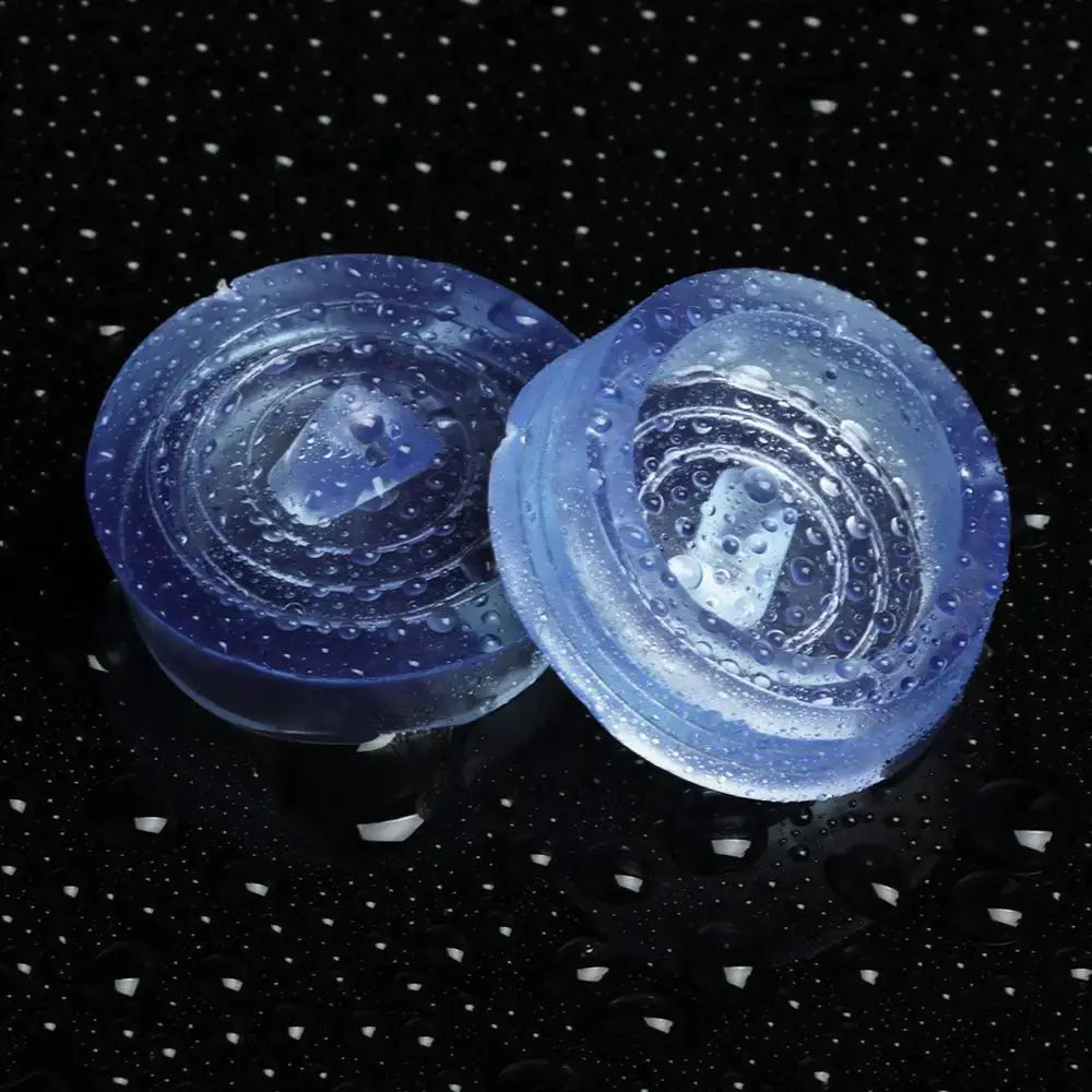 Two round blue silicone sink plugs and bathtub stoppers by Simples Market