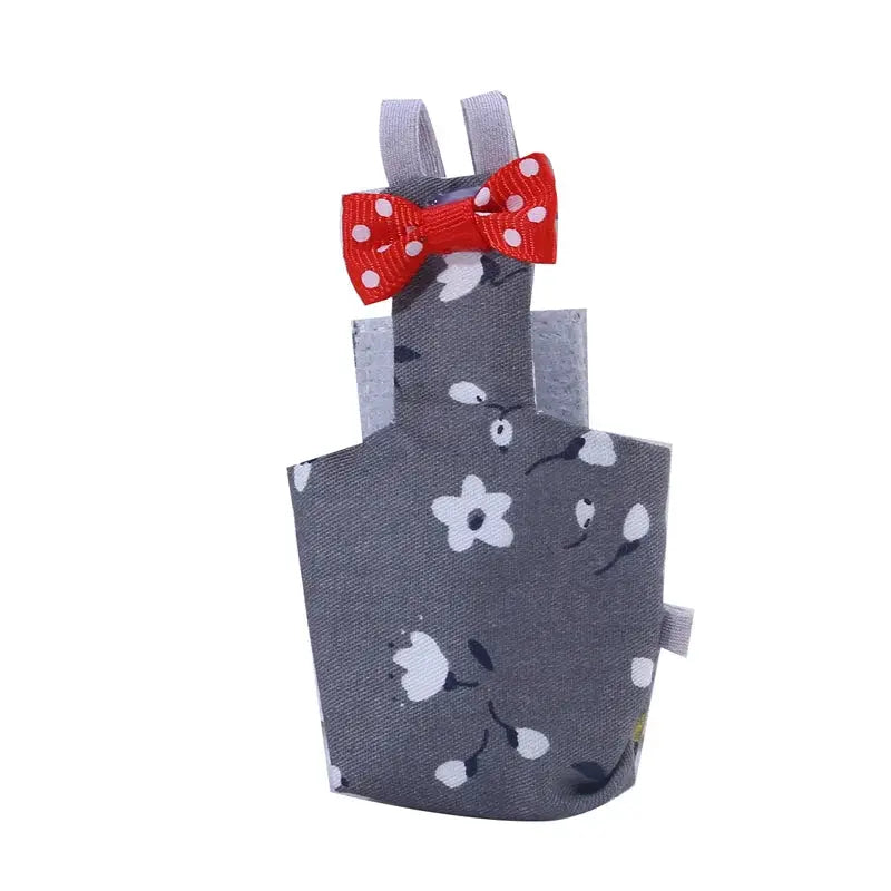 Parrot diaper flight suit in gray floral fabric with red polka-dot bow, washable