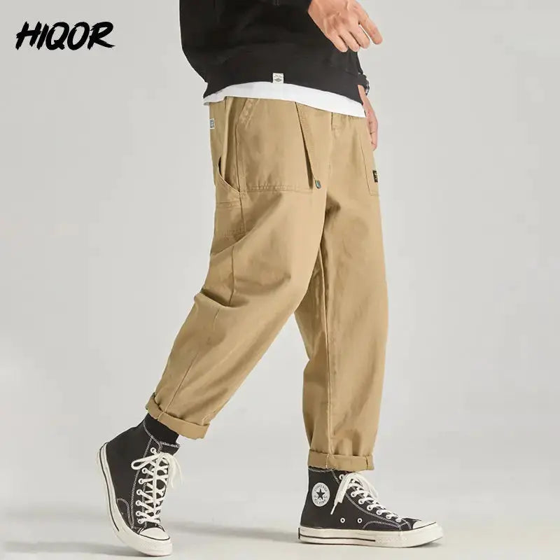HIQOR men's tan cargo pants with multiple pockets, baggy jogger fit, belt loops, styled with black high-top sneakers