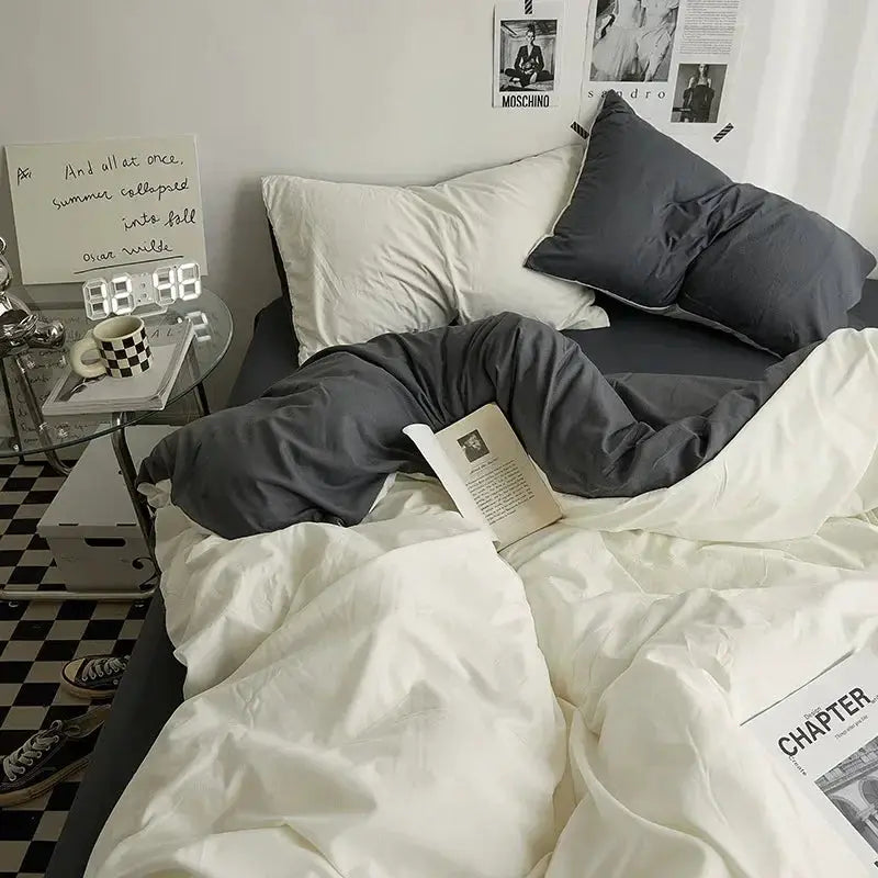 Solid-color cotton bedding 4-piece set on a dorm bed, white and charcoal gray duvet and pillows.