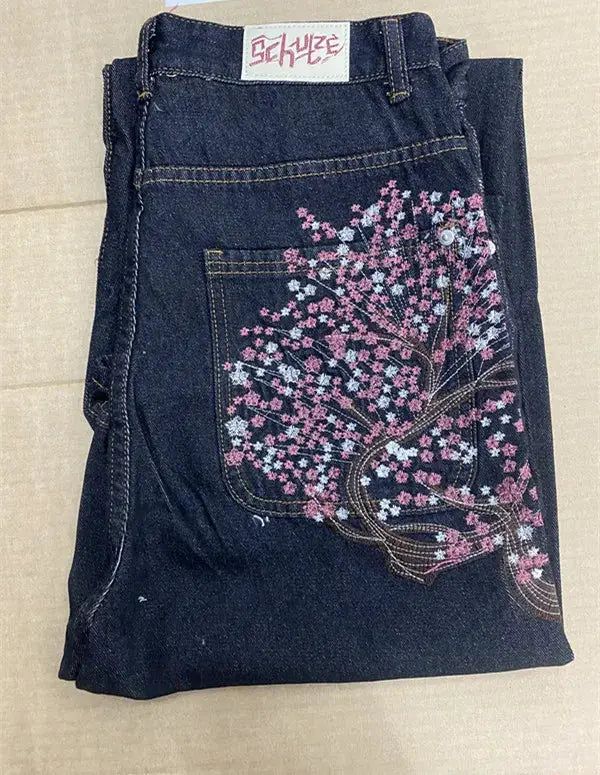 Denim jeans with cherry blossom embroidery on back pocket; dark indigo, wide-leg.